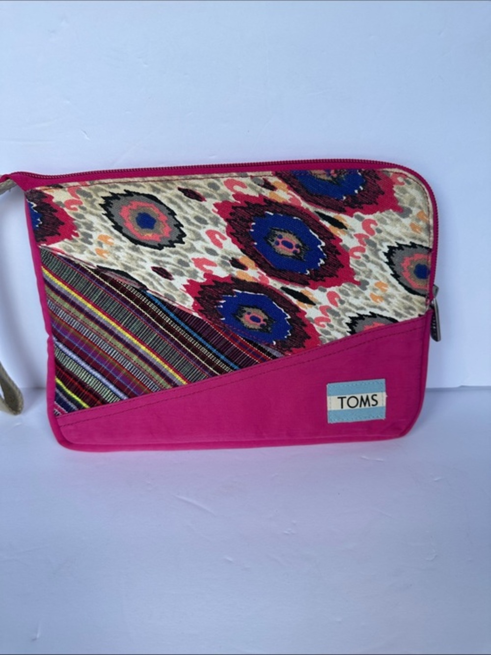 TOMS bag featuring a colorful ikat patterned top panel with wrist strap